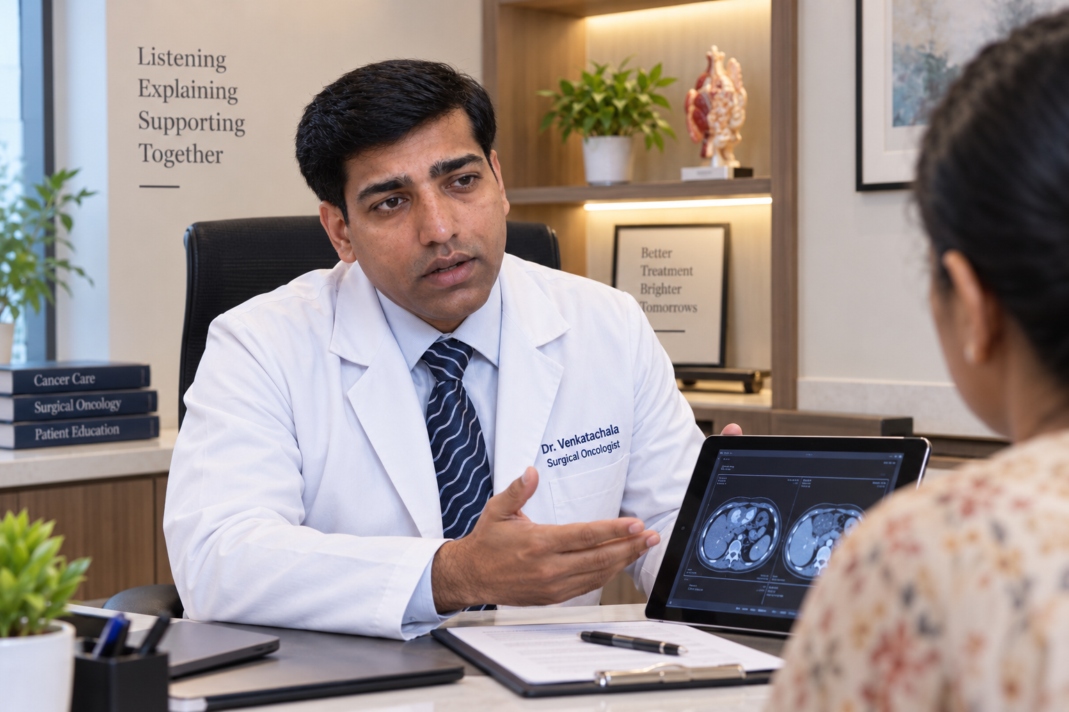 Dr. Venkatachala K explaining a scan to a patient at Surabhi Oncology